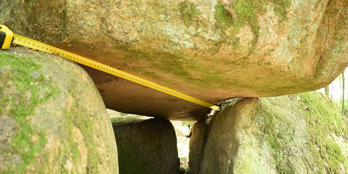 Dolmen in Borkowo. Block with cut marks. Visible unfolded measuring tape along probably cutted surface. Copyright: Paweł Kaczmarek