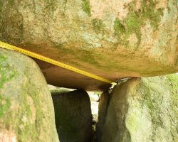 Dolmen in Borkowo. Block with cut marks. Visible unfolded measuring tape along probably cutted surface. Copyright: Paweł Kaczmarek